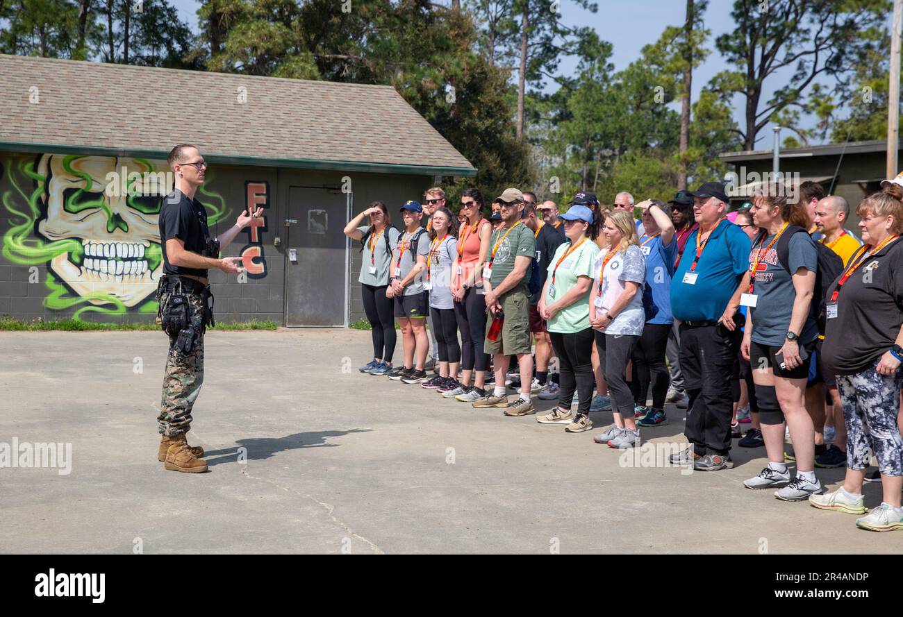 U.S. Marine Corps Staff Sgt. Corey Bradford, left, a marksmanship coach ...