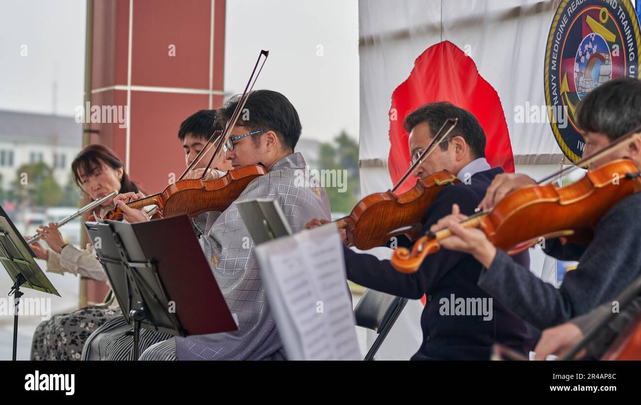 Medical doctors play musical instruments during a graduation ceremony