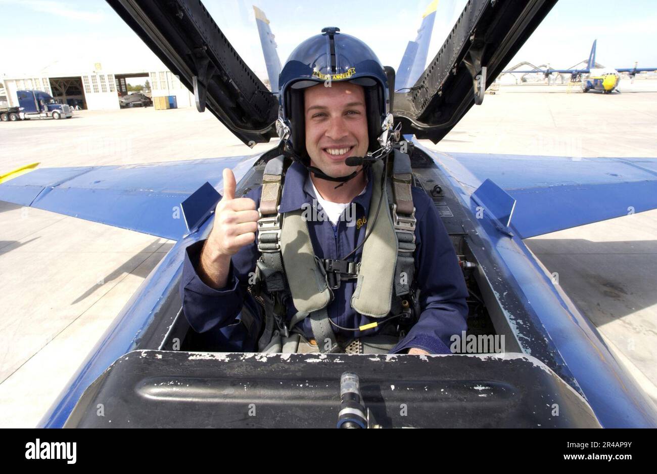 US Navy Fitz-Bradshaw racing team driver Scott Lagasse Jr. gives a thumbs up after being strapped into the back seat of an U.S. Navy's Flight Demonstration Team Blue Angels F-A-18A Hornet Stock Photo