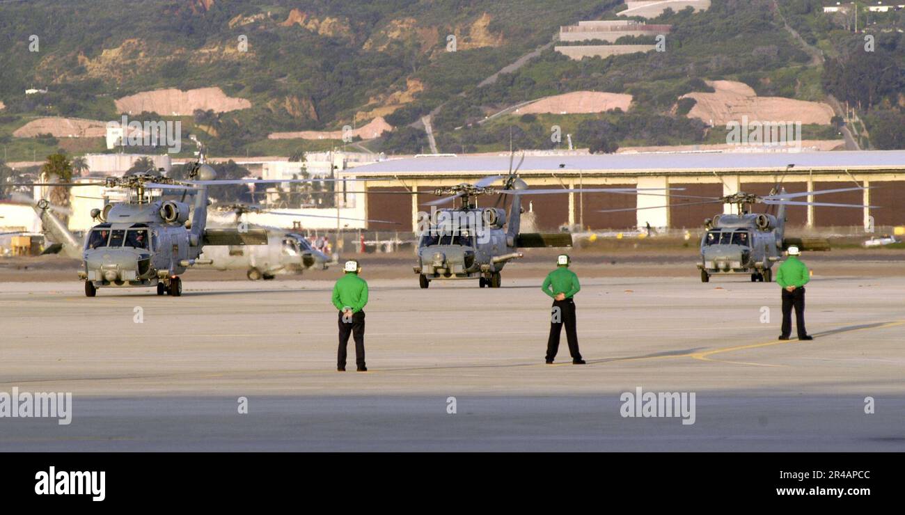 US Navy SH-60B Seahawk helicopters, assigned to the Saber Hawks of Helicopter Anti-Submarine Squadron Light Four Seven (HSL-47), taxi down the flight line Stock Photo