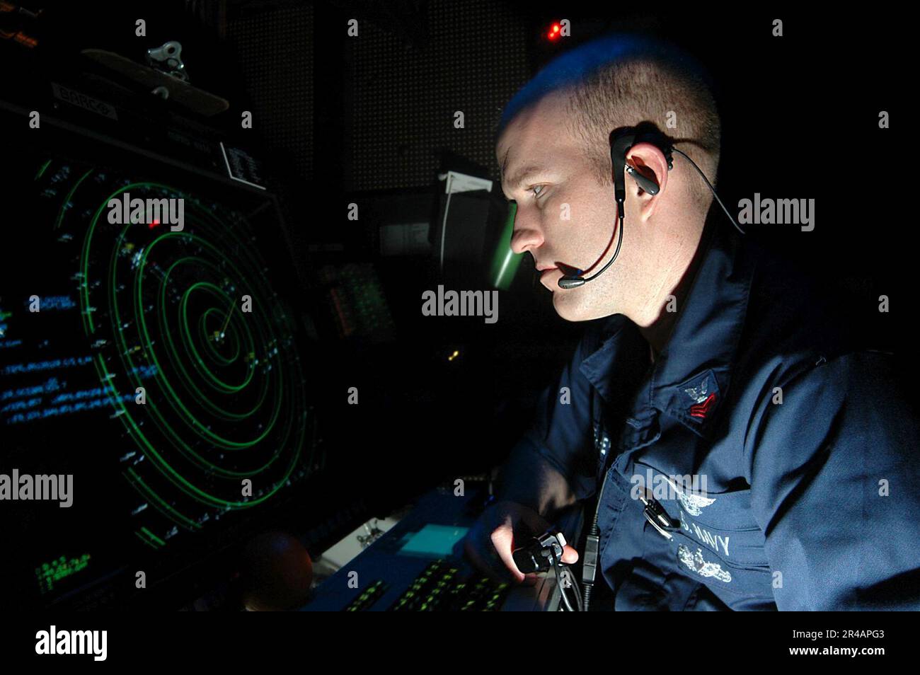 US Navy Air Traffic Controller 1st class monitors flight operations and tracks aircraft from the Carrier Air Traffic Control Center (CATCC) aboard the Nimitz-class aircraft carrier USS Carl Vins Stock Photo
