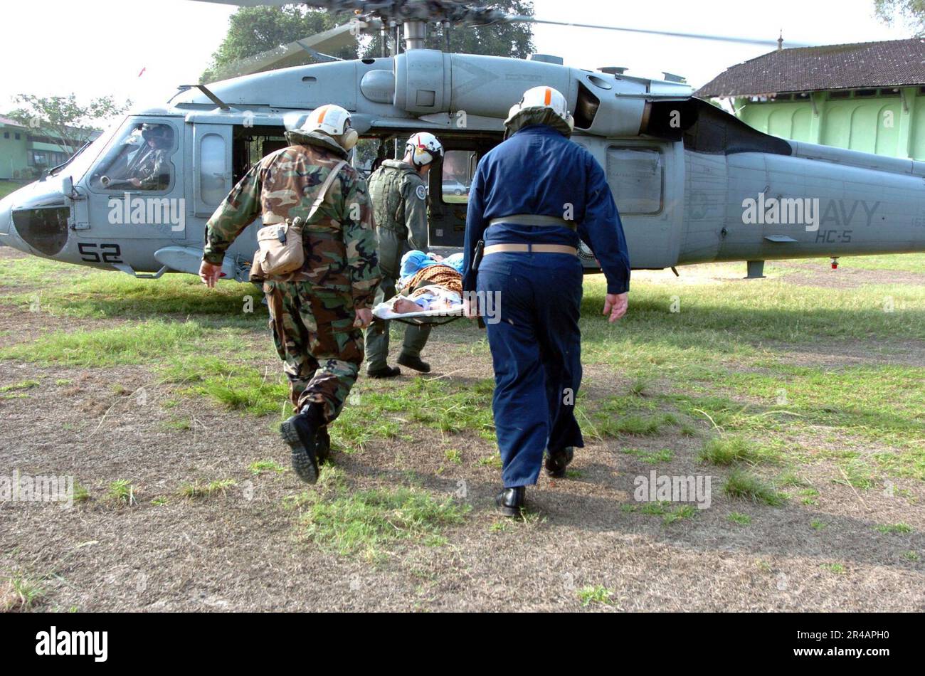 US Navy Military personnel carry an Indonesian patient to a U.S. Navy