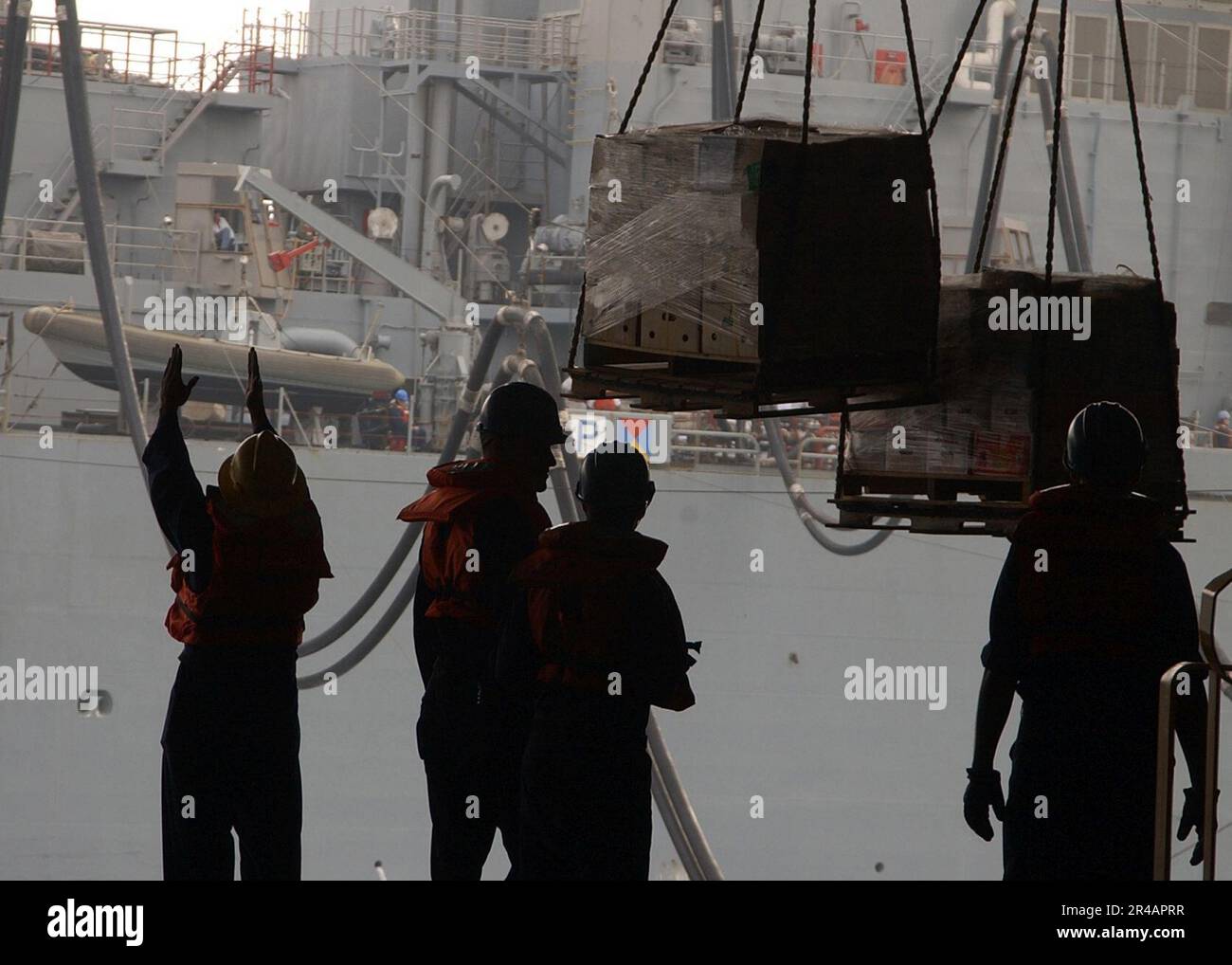 US Navy A Rig Captain, left, signals to the Military Sealift Command ...