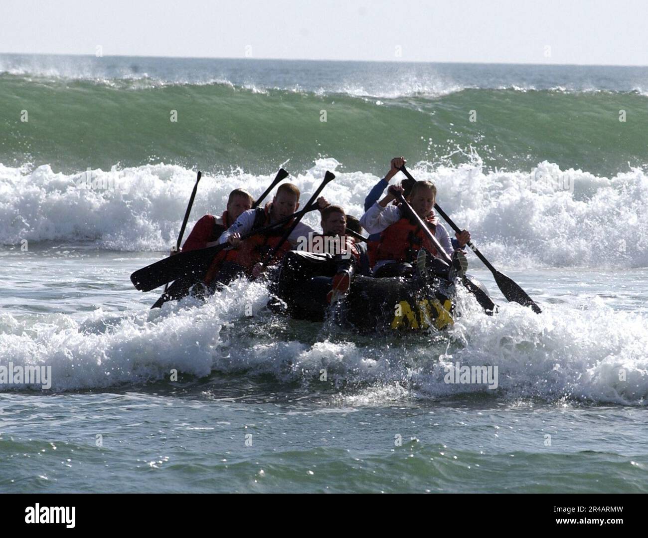 US Navy  U.S. Olympic Team triathletes maneuver a rubber raft in the surf during a day of training with Navy SEALs (Sea, Air, Land) on board Naval Special Warfare Center, San Diego, Calif. Stock Photo