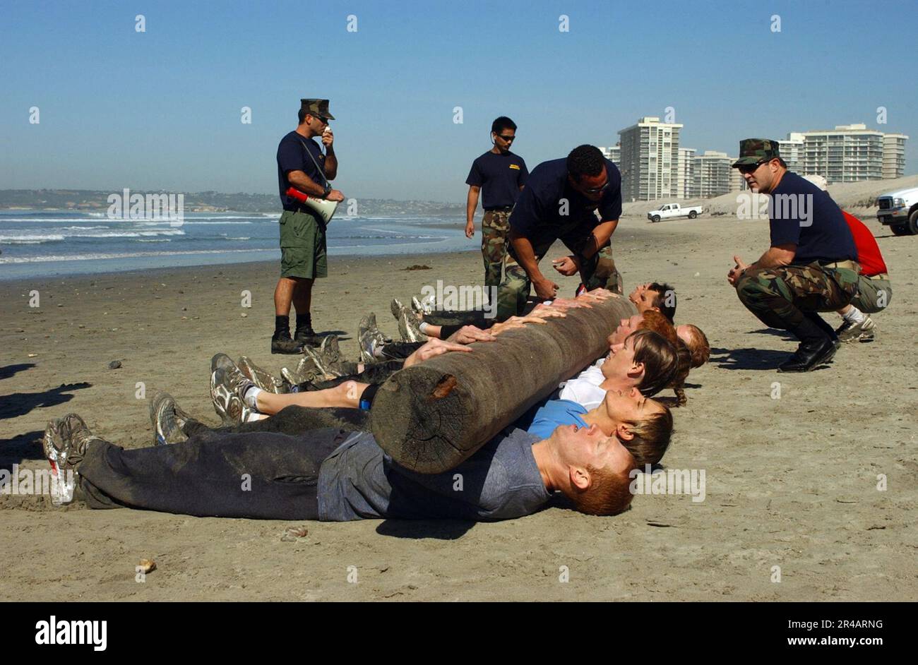 US Navy  U.S. Olympic Team triathletes perform physical fitness with a large log during a day of training with Navy SEALs (Sea, Air, Land) on board Naval Special Warfare Center, San Diego, Calif. Stock Photo