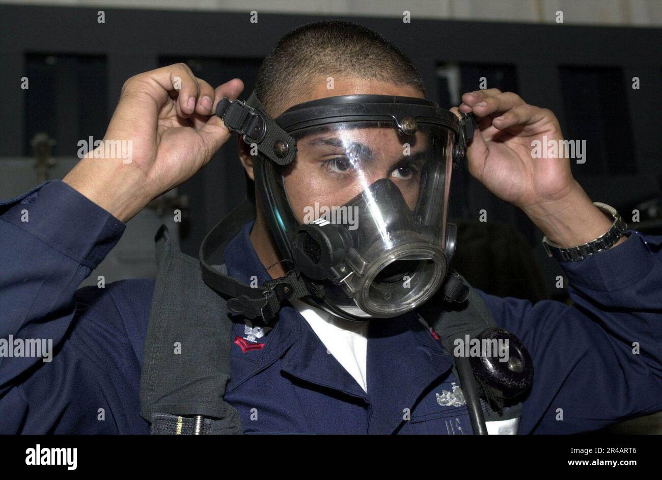 US Navy Damage Controlman 2nd class demonstrates the proper way to don