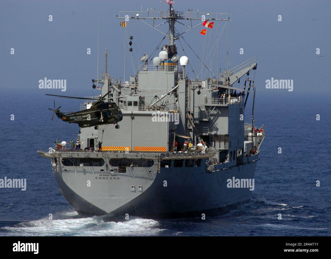 US Navy A UH3H Sea King helicopter picks up a pallet of supplies from