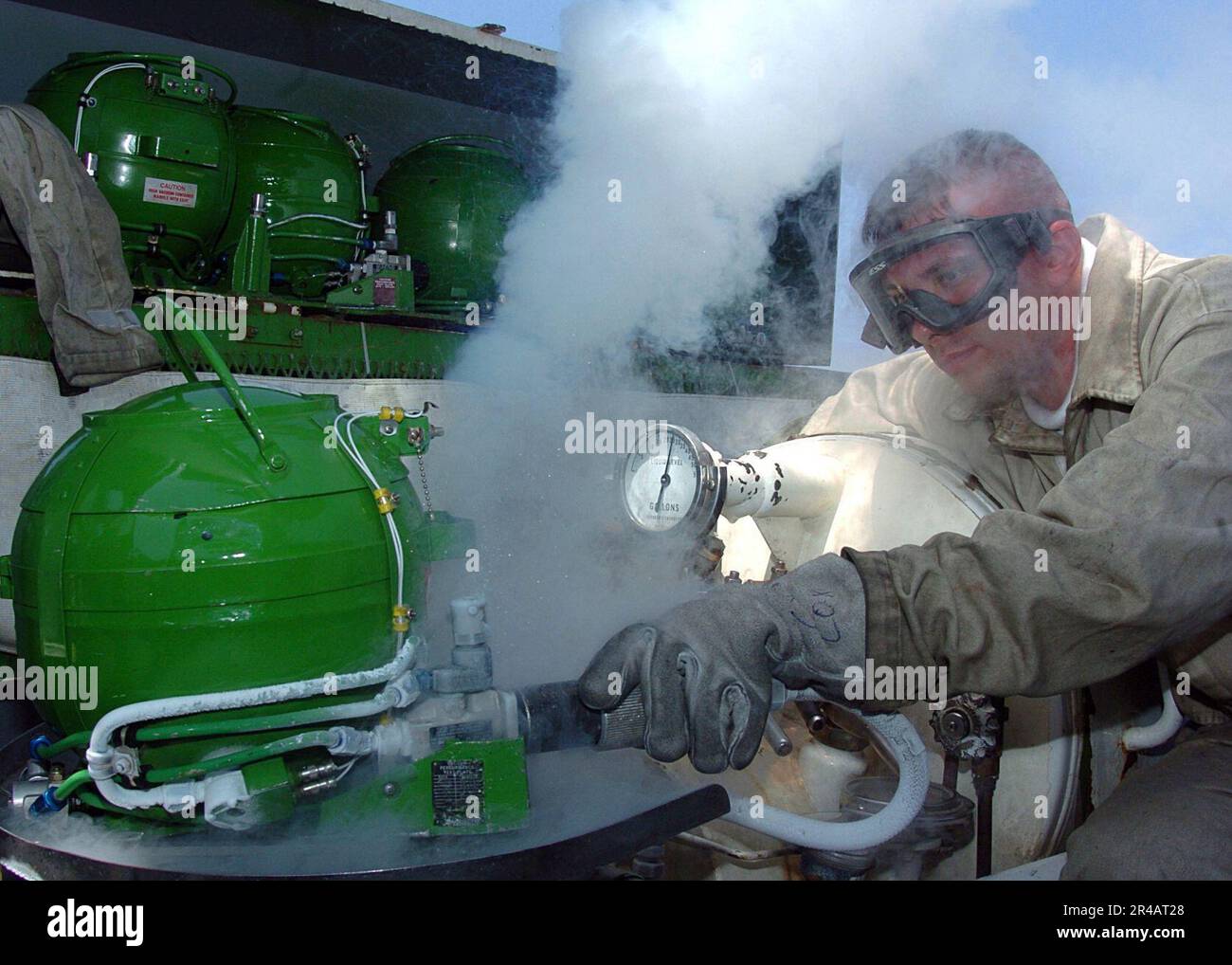 US Navy A Sailor fills aircraft oxygen tanks with liquid oxygen on the flight deck aboard the