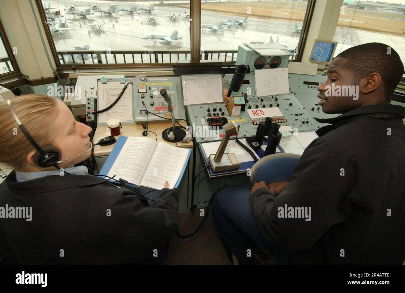 US Navy Air Traffic Controller 2nd Class left, conducts onthejob