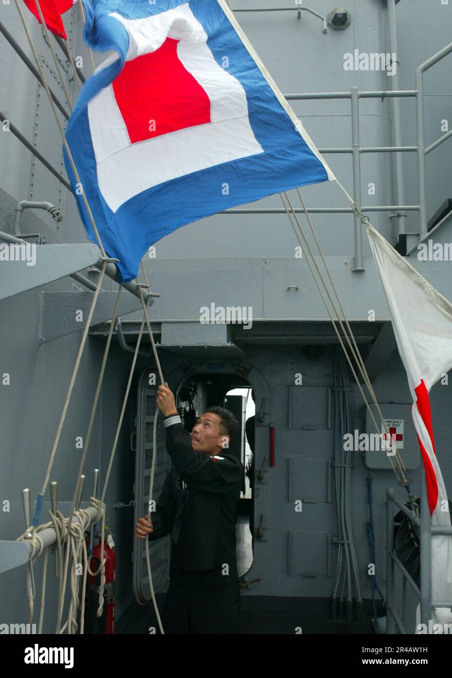 US Navy Quartermaster 2nd Class raises the CodeWhiskeyUniformPennant