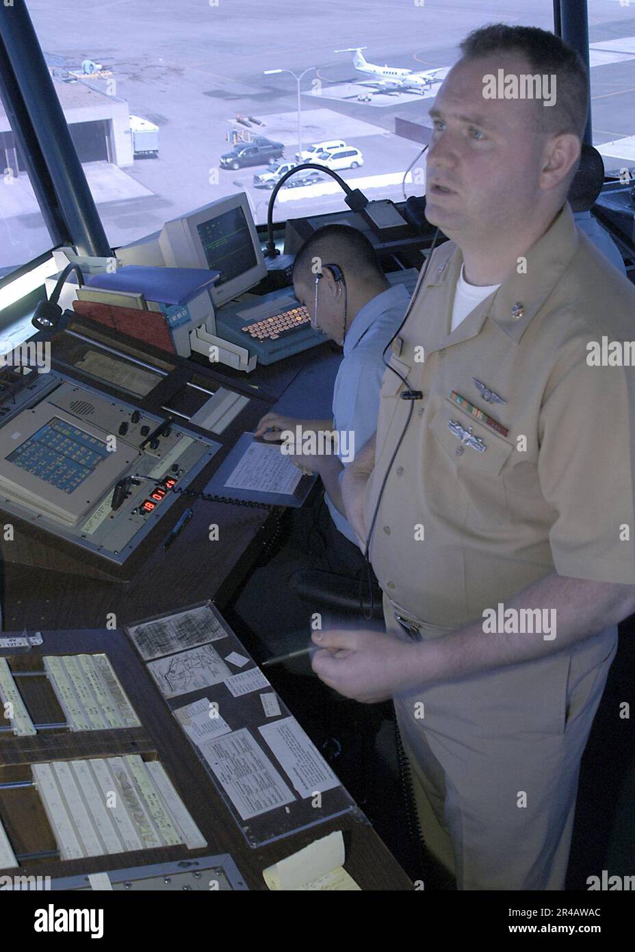 US Navy Chief Air Traffic Controller observes aircraft as he clears