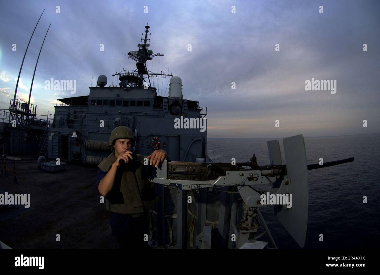 US Navy Seaman mans the forward lookout onboard amphibious transport ...