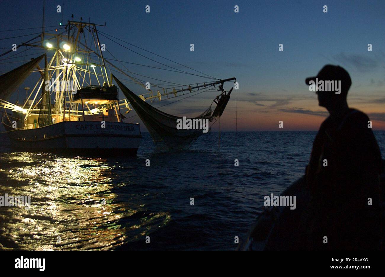 US Navy U.S. Coast Guard Petty Officer 3rd Class sits on a 26foot
