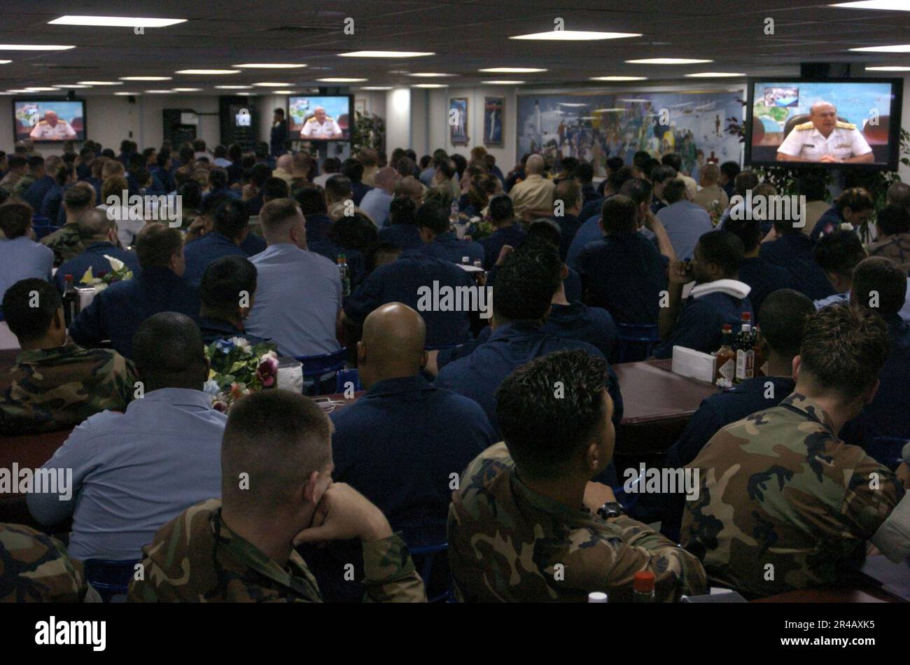 US Navy  Crew members watch via video teleconference as Chief of Naval Operations Adm. Vern Clark and Master Chief Petty Officer of the Navy Terry Scott congratulate the crew. Stock Photo