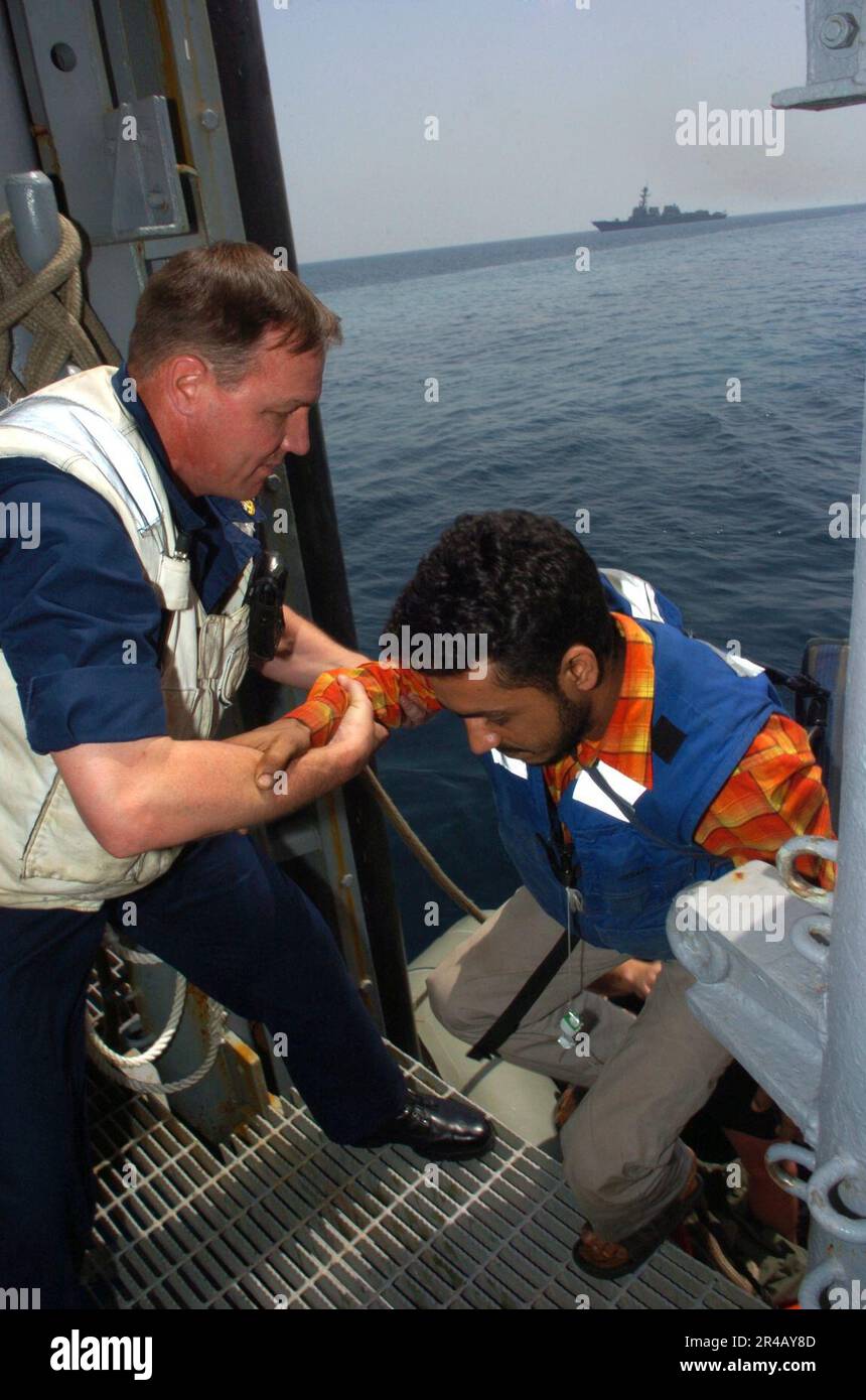 US Navy Senior Chief Boatswain's Mate assists a Motor Vessel Olympias