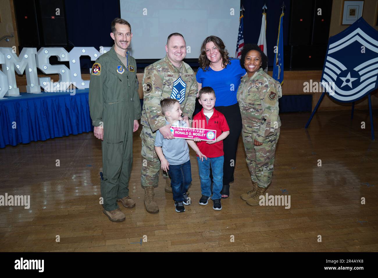 U.S. Air Force Col. Michael P. Richard, 35th Fighter Wing commander, and Chief Master Sgt. Cheronica Blandburg, 35th FW command chief, pose for a photo with Master Sgt. Ronald Mosley, 35th Maintenance Squadron, and his family during an E-8 release party at Misawa Air Base, Japan, March 23, 2023. Air Force officials selected 1,629 master sergeants for promotion to senior master sergeant, out of 16,031 eligible, for a selection rate of 10.16 percent in the 23E8 promotion cycle. Stock Photo