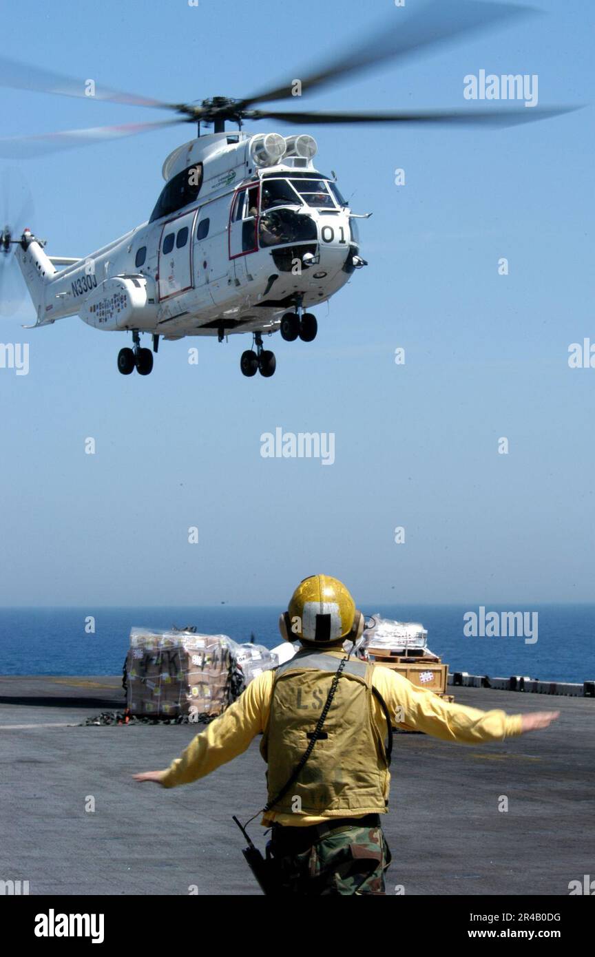 US Navy  An SA 330 Puma helicopter drops delivers stores during a vertical replenishment aboard the amphibious assault ship USS Kearsarge (LHD 3). Stock Photo