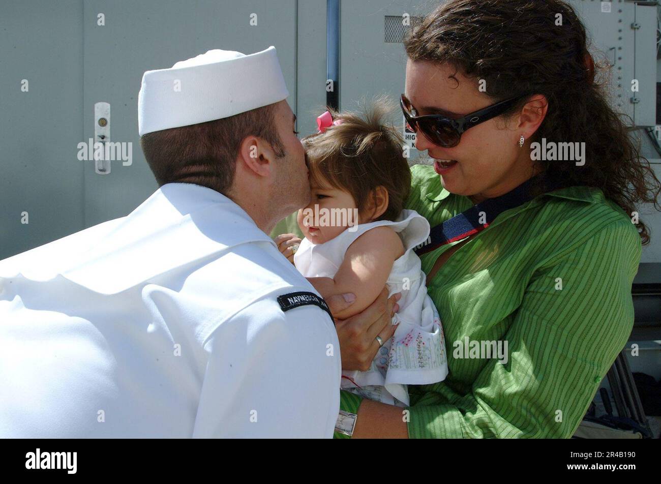 US Navy Journalist 1st Class kisses his baby on the pier after getting ...