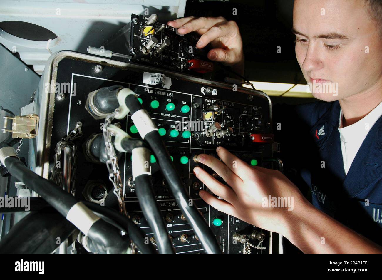US Navy Aviation Electrician's Mate 3rd Class performs maintenance on
