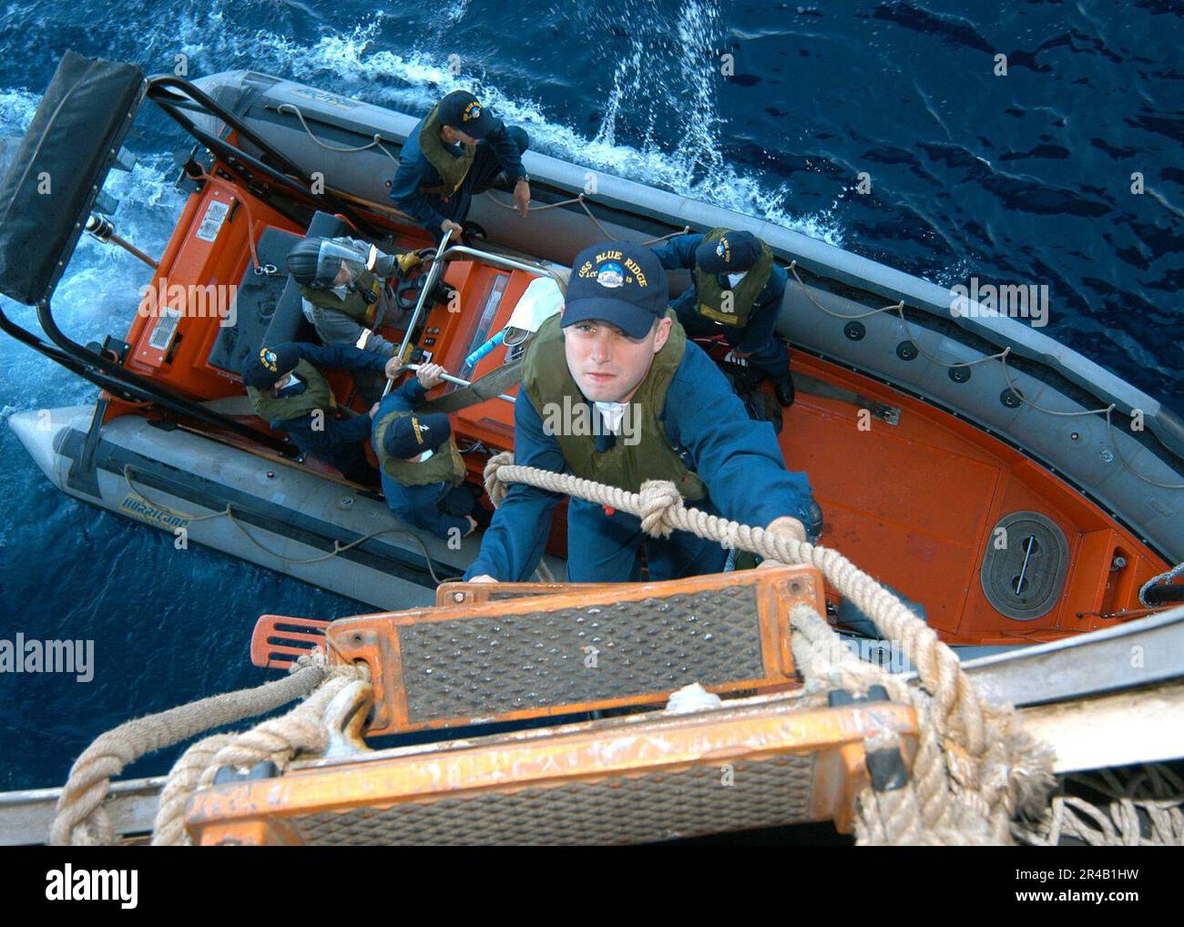 US Navy Boatswain's Mate 3rd Class climbs the Jacob's Ladder into a