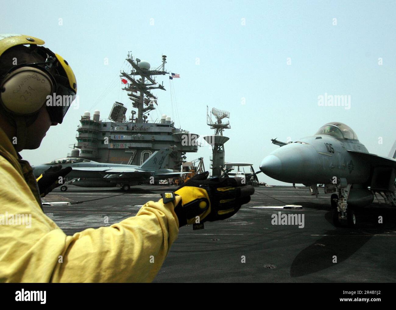 US Navy An Aviation Boatswain's Mate uses hand signals to communicate