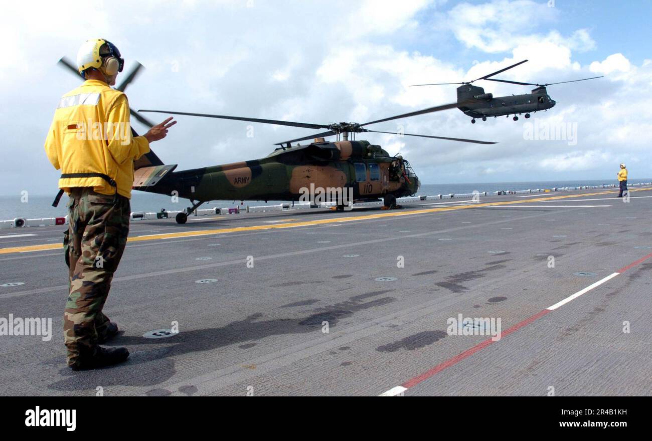 US Navy  An Australian Army S70A-9 Black Hawk and a CH-47D Chinook assigned to Australian 5th Aviation Regiment, conduct flight operations from the flight deck of the amphibious assault ship USS Boxer (LHD 4). Stock Photo