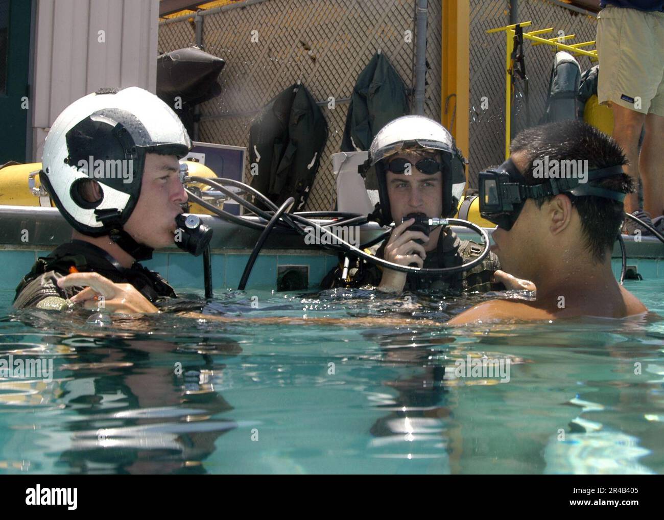US Navy  Two students prepare to submerge and breathe from SCUBA tanks as part of a familiarization course in the use of the Helicopter Emergency Escape Device at Aviation Survival Training Center. Stock Photo