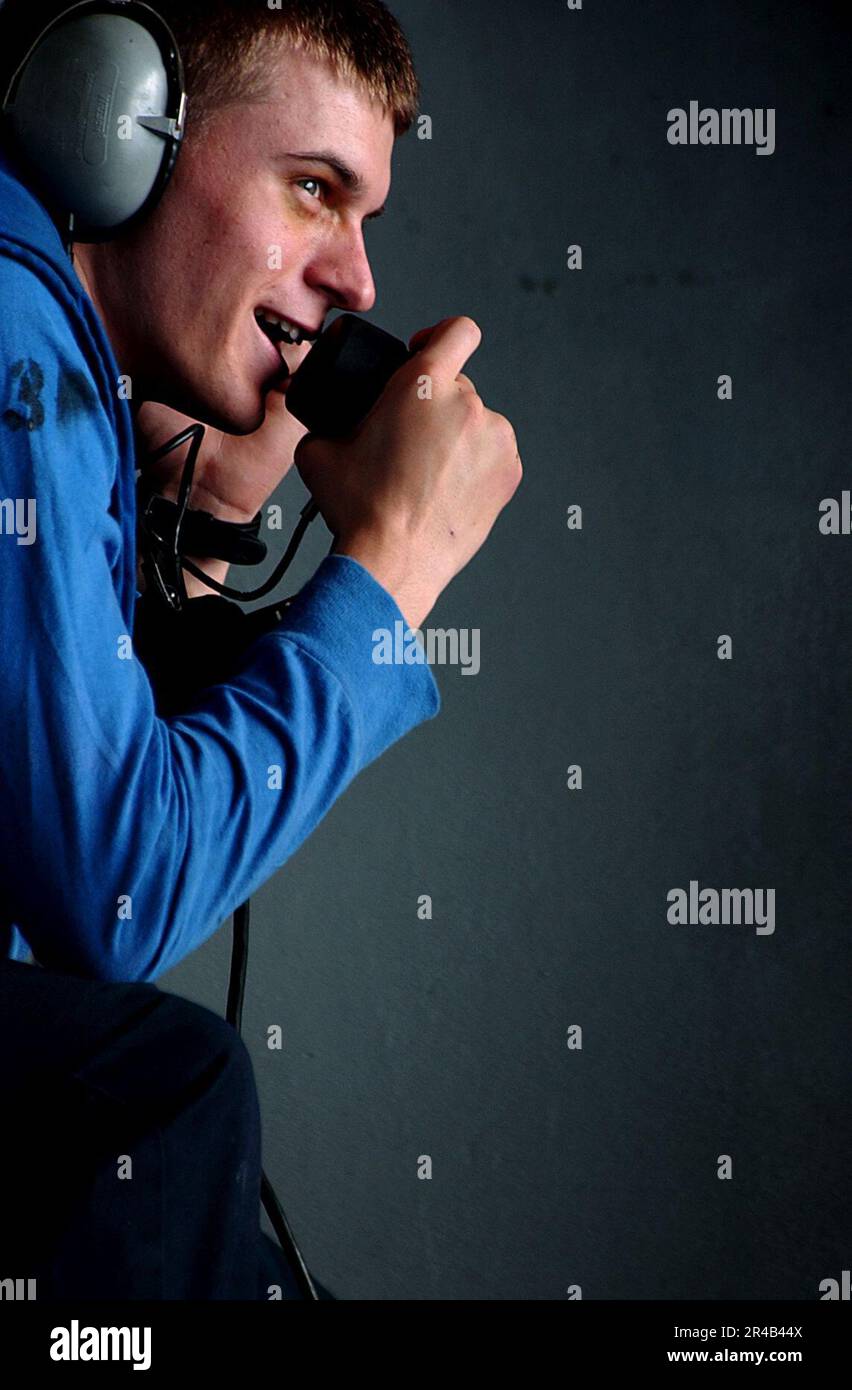 US Navy Airman talks on a sound powered phone Stock Photo Alamy