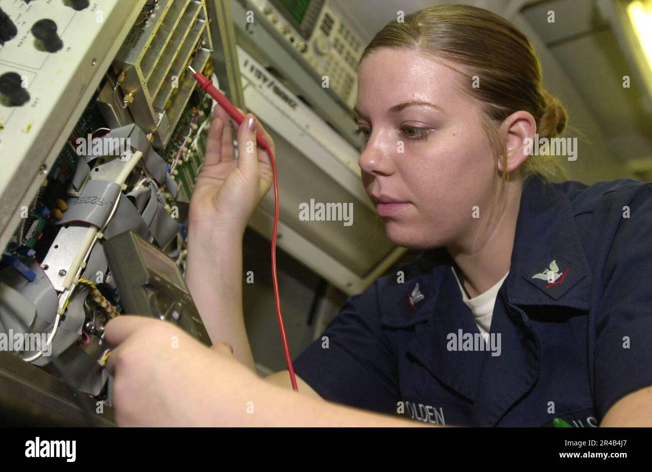 US Navy Aviation Electronics Technician 3rd Class reads a digital multi
