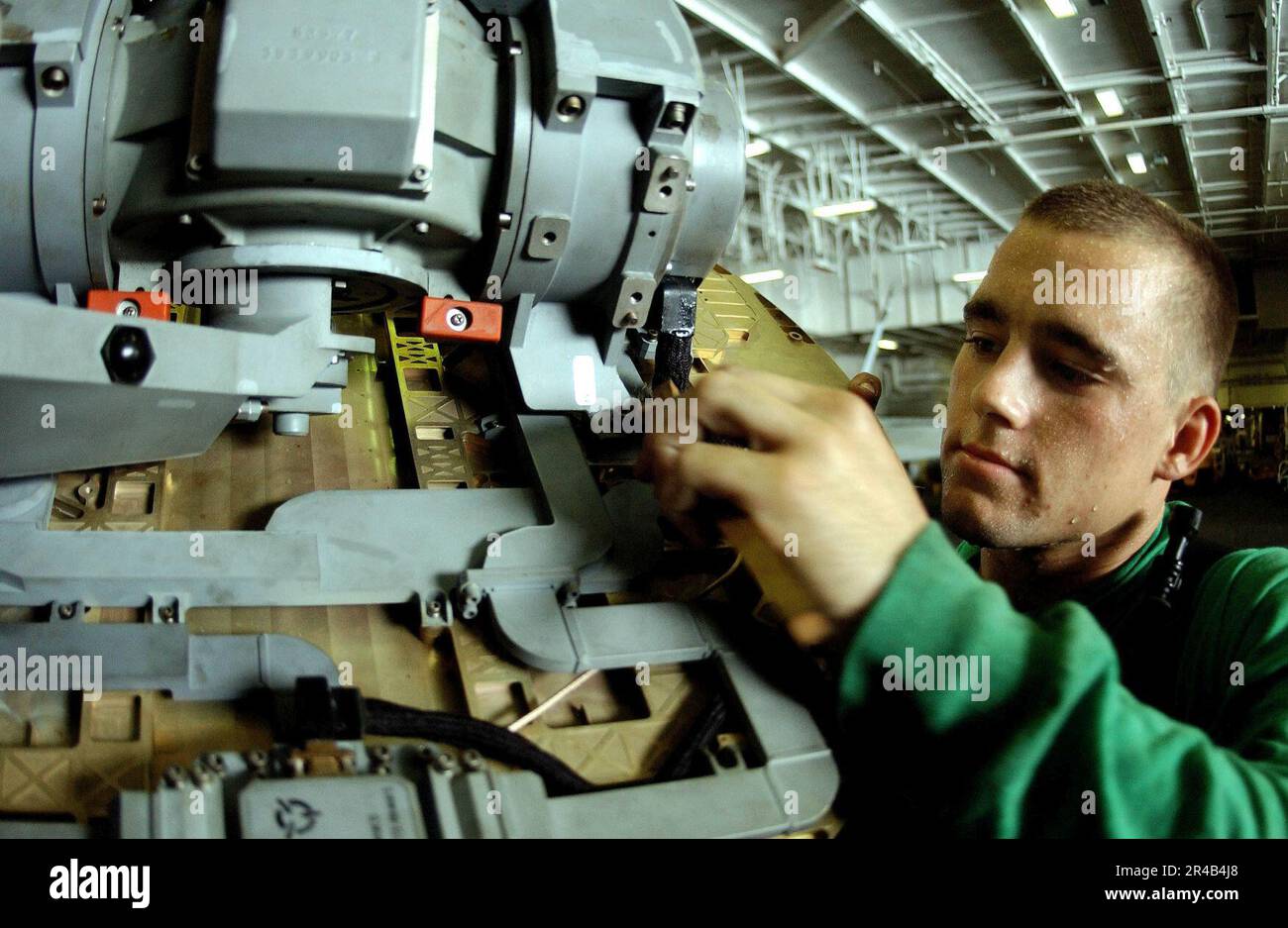 US Navy Aviation Electronics Technician 3rd Class cleans a radar on an