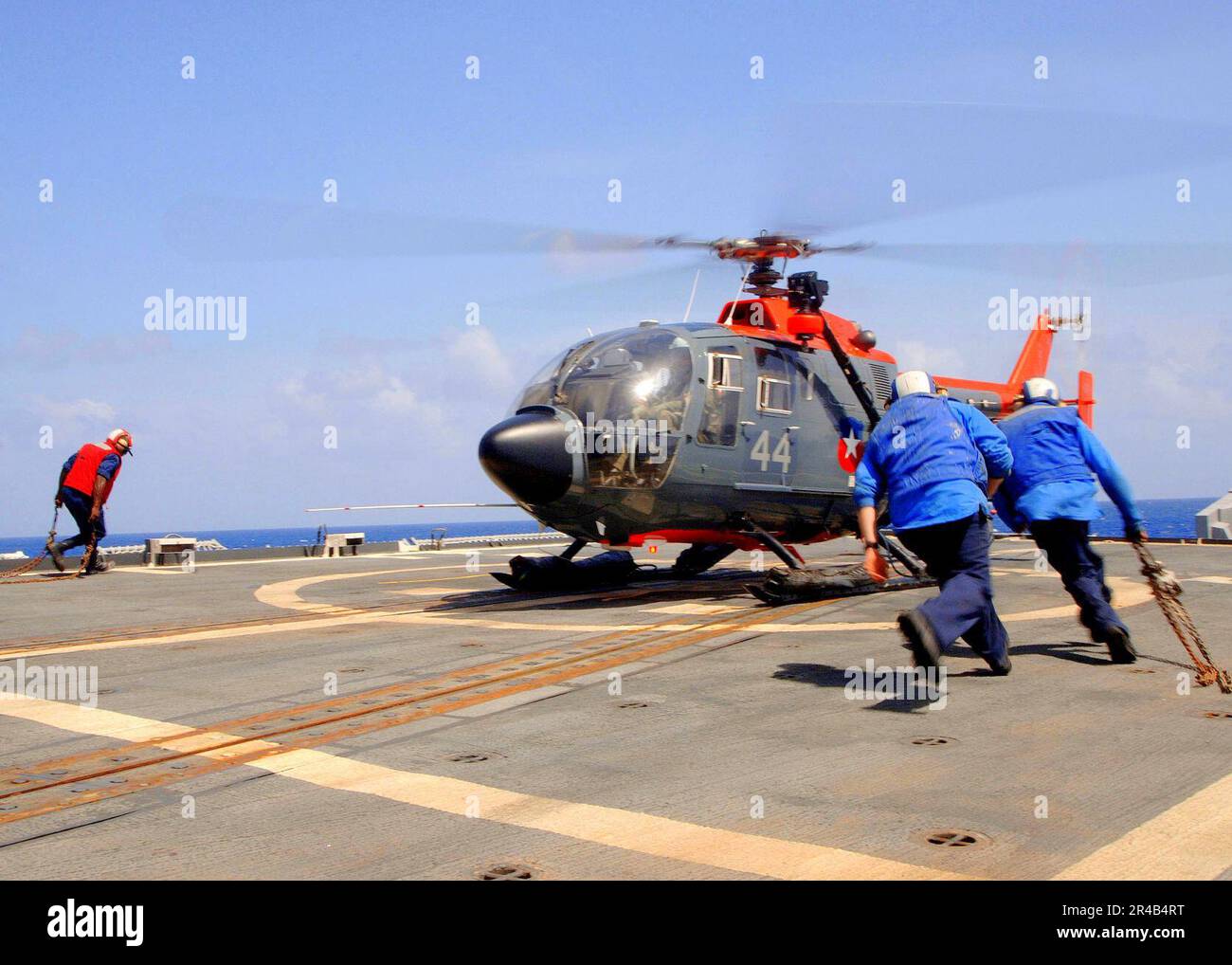 US Navy Flight deck personnel assigned to the guided missile cruiser ...