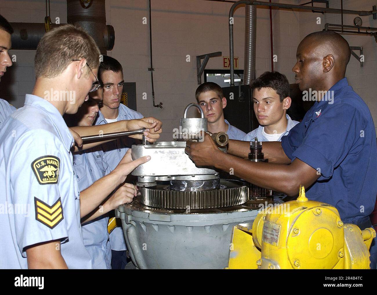 US Navy Aviation Machinist's Mate 2nd Class right, teaches U.S. Naval