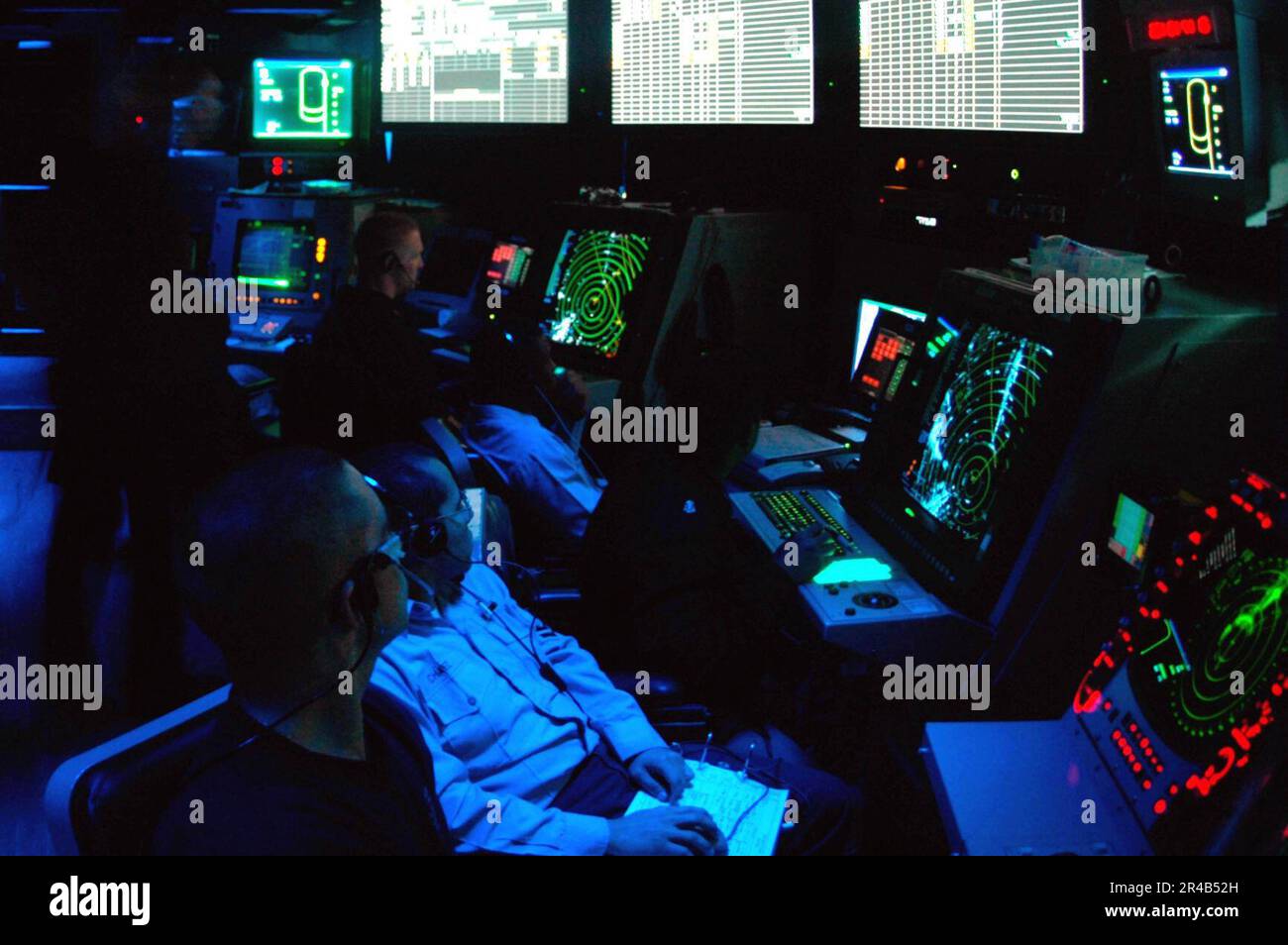 US Navy  Air Traffic Controllers stand watch in the Carrier Air Traffic Control Center (CATCC) aboard the nuclear-powered aircraft carrier USS Nimitz (CVN 68). Stock Photo