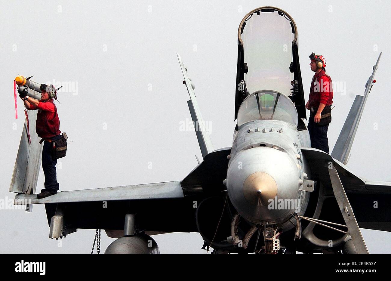 US Navy  Aviation Ordnancemen from the Stingers of Strike Fighter Squadron One One Three (VFA-113) conduct a pre-flight ordnance inspection. Stock Photo