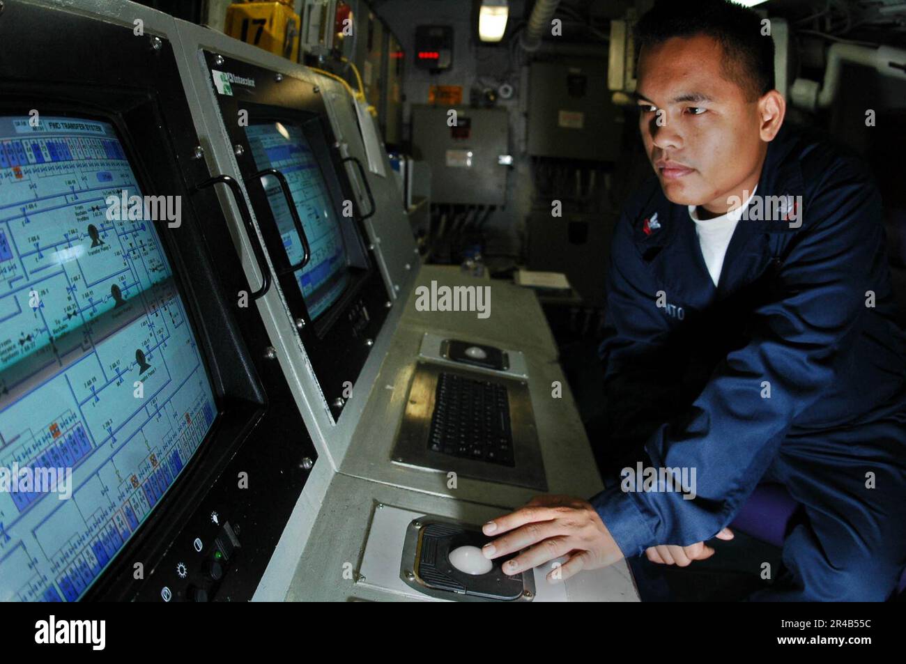 US Navy Aviation Boatswain's Mate 2nd Class monitors fuel levels in the