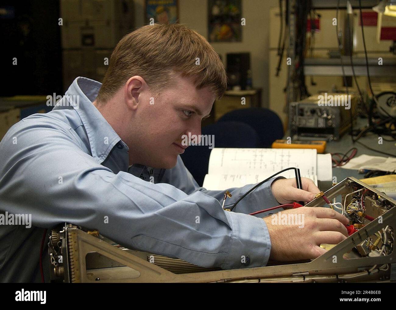 US Navy Aviation Electronics Mate Airman performs an inspection on the