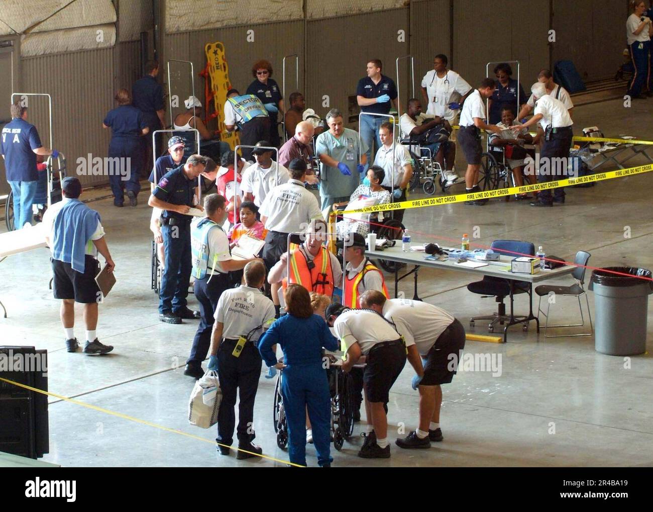US Navy  Local Fire and Rescue personnel, Veterans Affairs and other medical services from the Dallas-Fort Worth area, register and classify injured, ill and displaced residents of the New Orleans and surround. Stock Photo