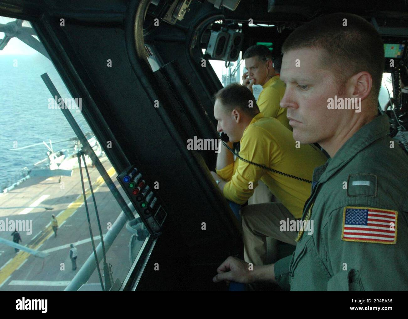 US Navy  Lt.j.g. oversees flight deck operations from Primary Flight Control aboard the amphibious assault ship USS Iwo Jima (LHD 7). Stock Photo