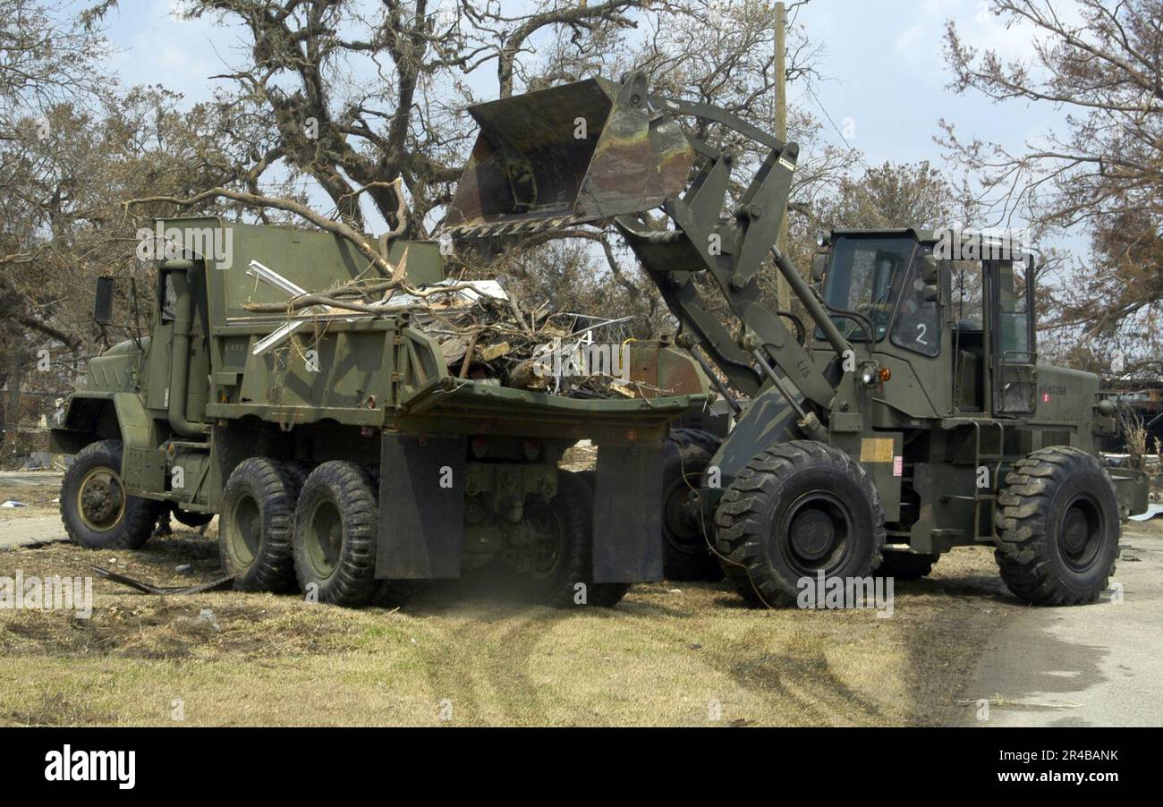 US Navy A U.S. Navy Seabee bulldozer dumps Hurricane Katrina debris into a dump truck during