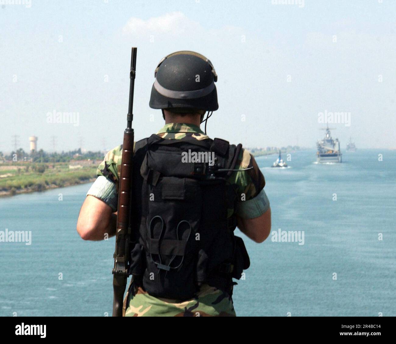US Navy MasteratArms 2nd Class stands a flight deck security patrol as the amphibious assault