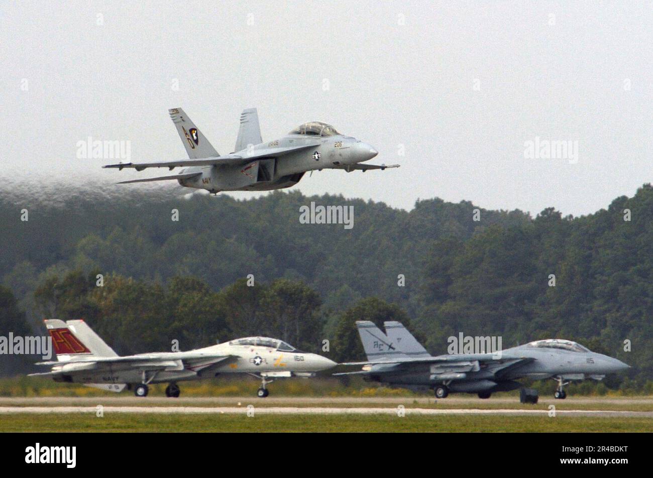 US Navy An FA18F Super flies over two F14 Tomcats during the