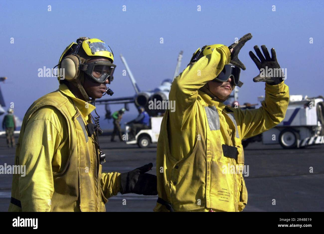 US Navy Aviation Boatswain Mate 1st Class right, directs an FA18F