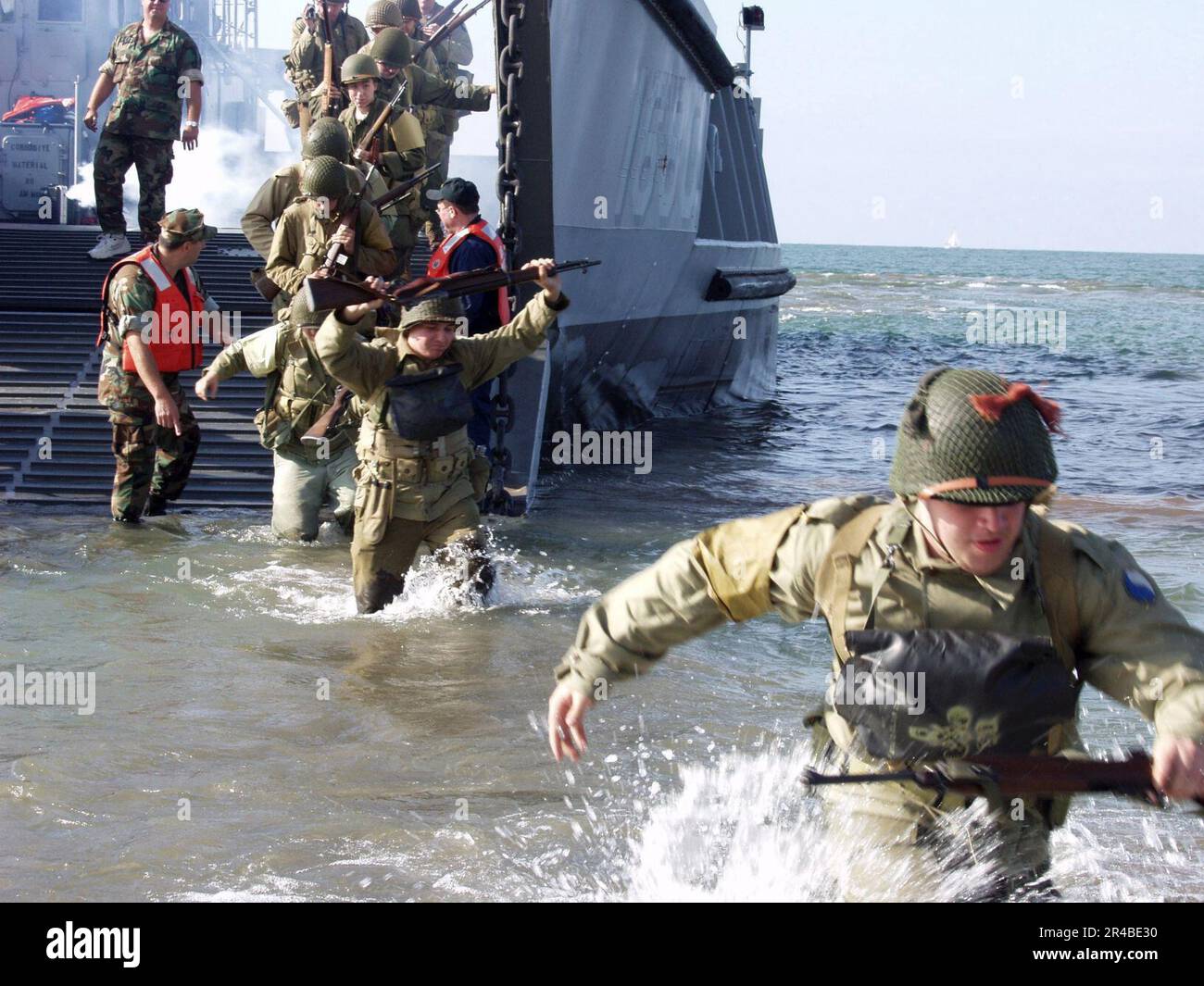 US Navy Actors portraying soldiers from World War II, depart a landing