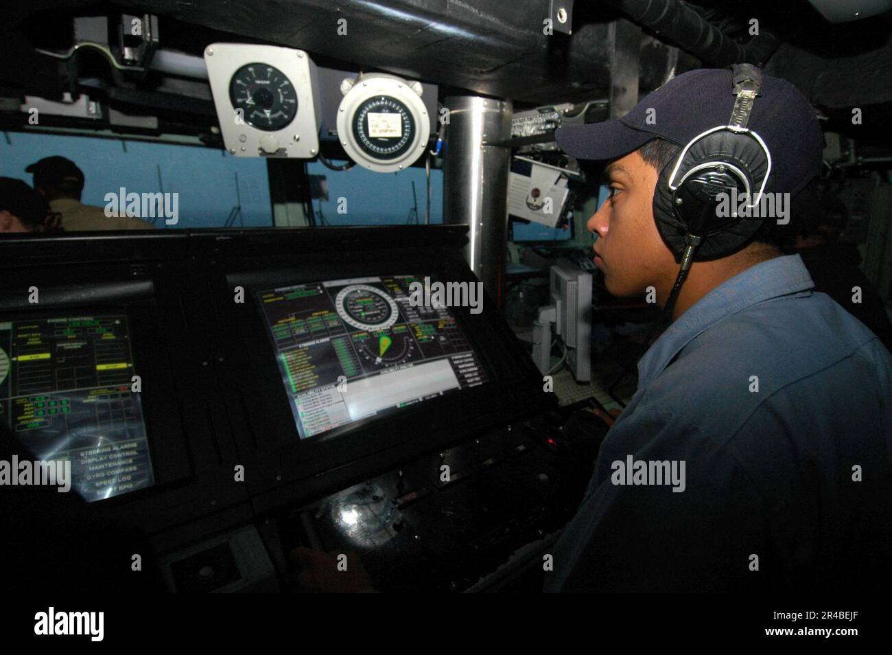 US Navy Seaman steers the amphibious assault ship USS Iwo Jima (LHD 7 ...