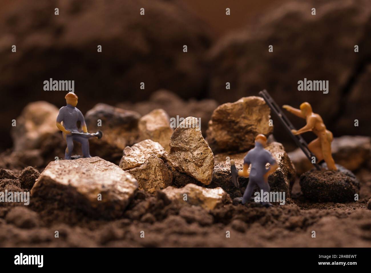 Miniature worker mining stone, metal, gold, lead, copper, zinc and