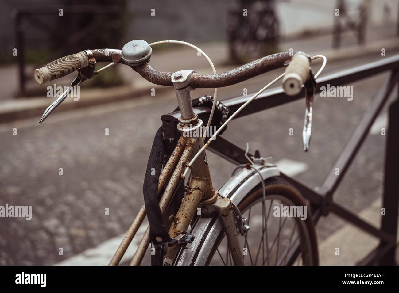 A vintagestyle bicycle placed in front of a metal railing, overlooking
