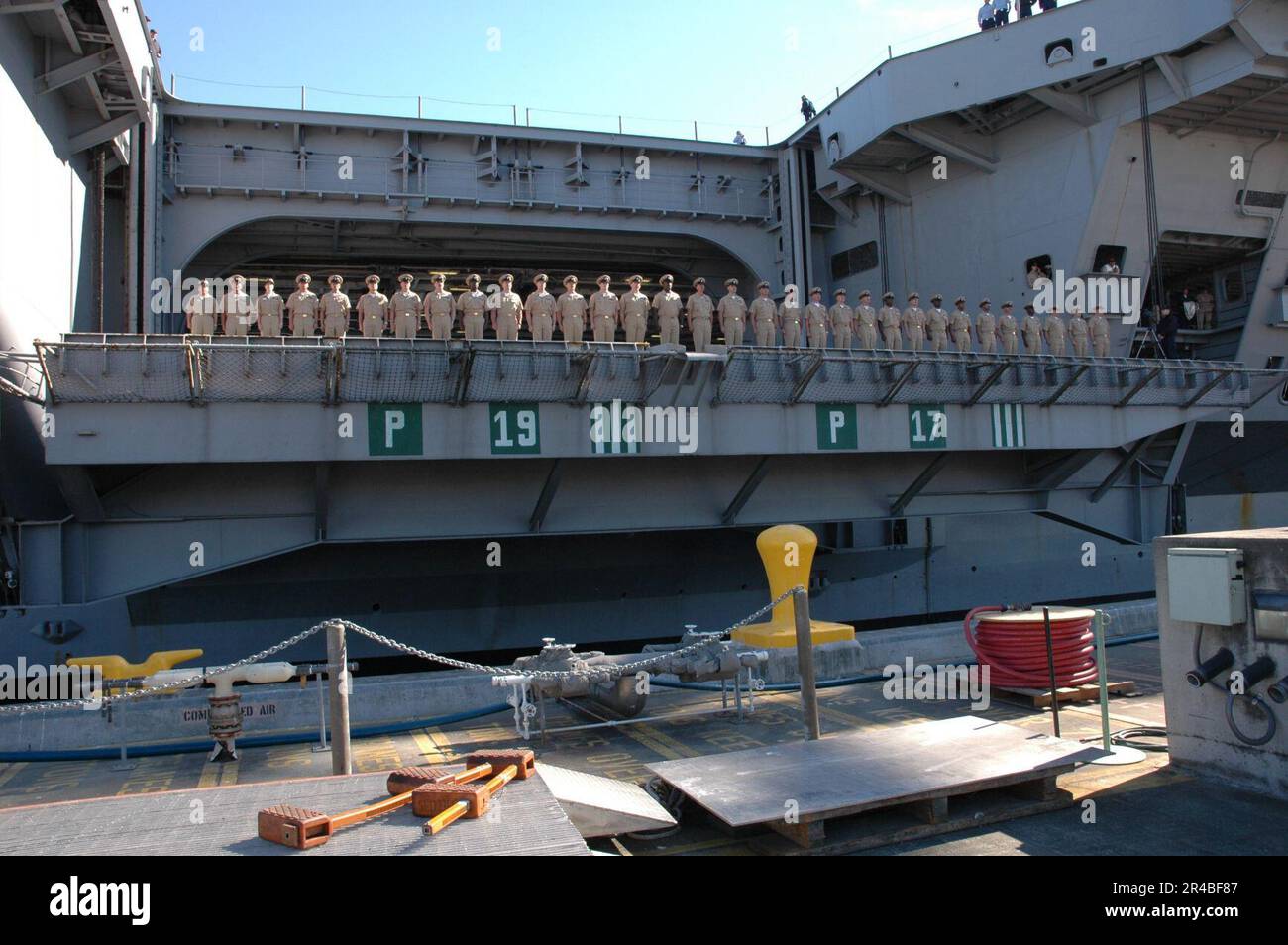 US Navy Newly promoted chief petty officers stand at attention as they