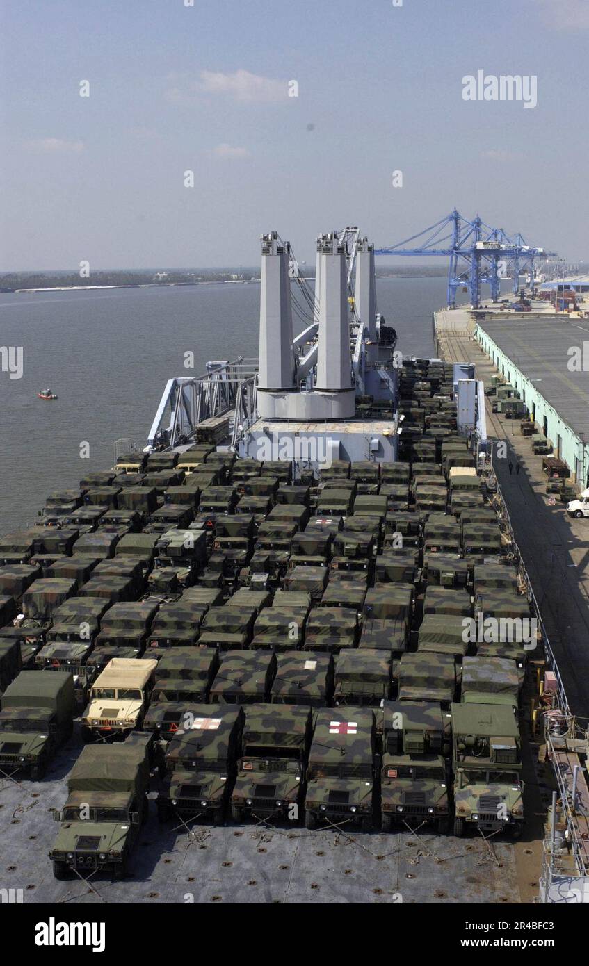 US Navy  U.S. Army High Mobility Multipurpose Wheeled Vehicles (HMMWV) are loaded onto the Military Sealift Command (MSC) large, medium-speed roll-on-roll-off ship USNS Pililaau (T-AKR 304). Stock Photo