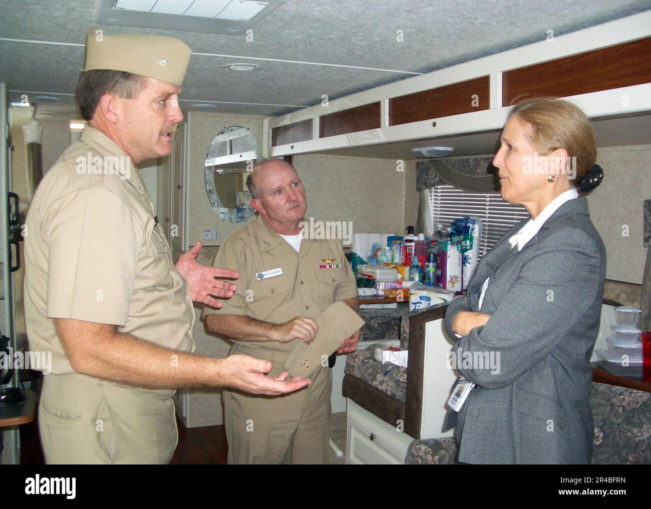 US Navy  Capt. shows donated goods to Commander, Task Force Navy Family, Rear Adm. Robert O. Passmore and Deputy Commander, Task Force Navy Family, Ms. Debra J. Edmond. Stock Photo