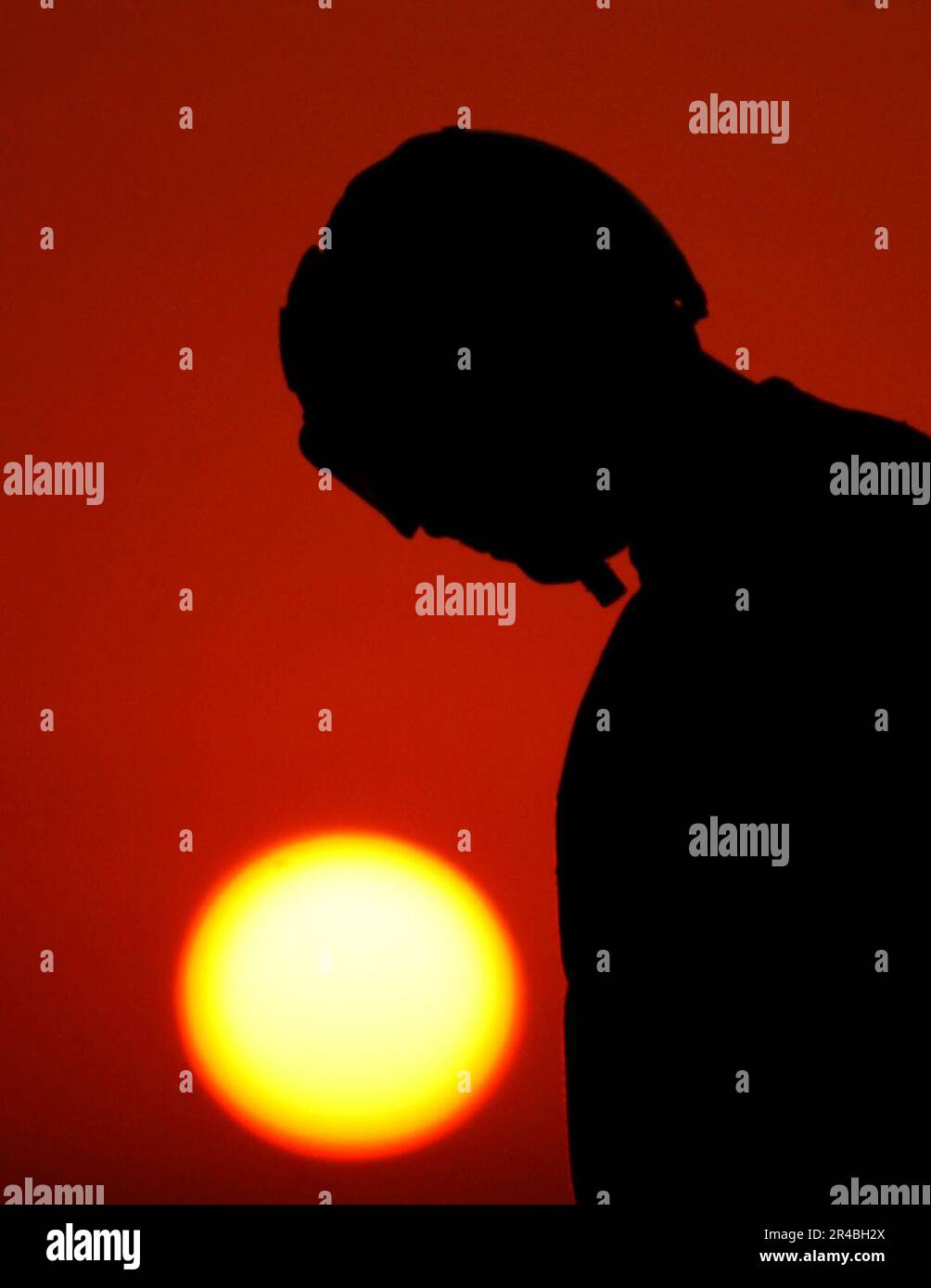 US Navy A plane captain gathers tiedown chains to secure landing aircraft during evening flight